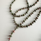 Beaded necklace with unakite 2mmx4mm beads on a light background