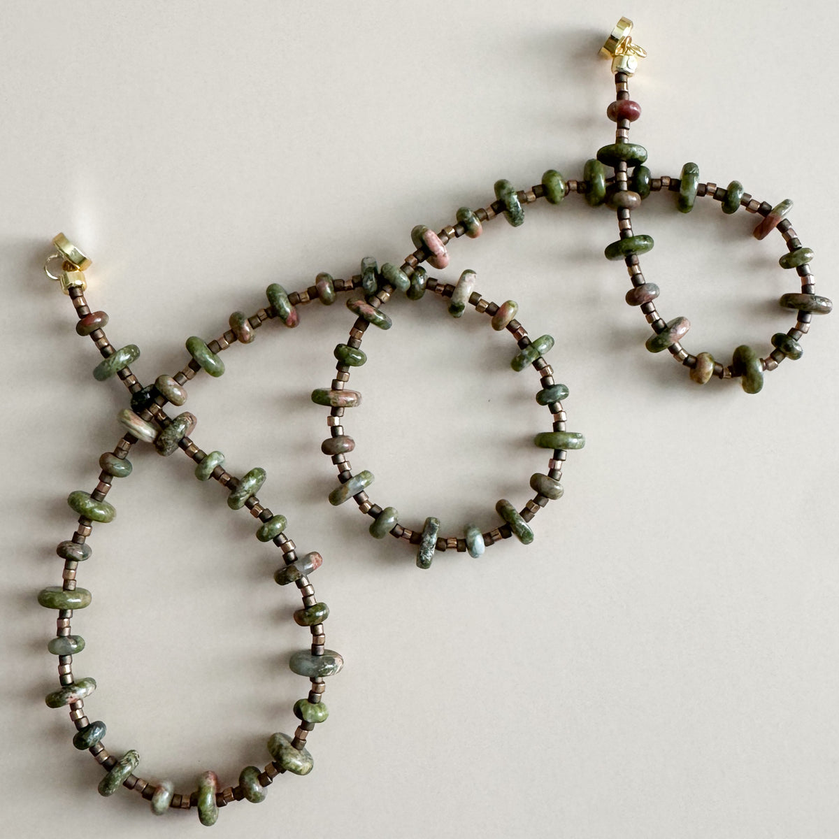 Beaded necklace and bracelet set on a light background