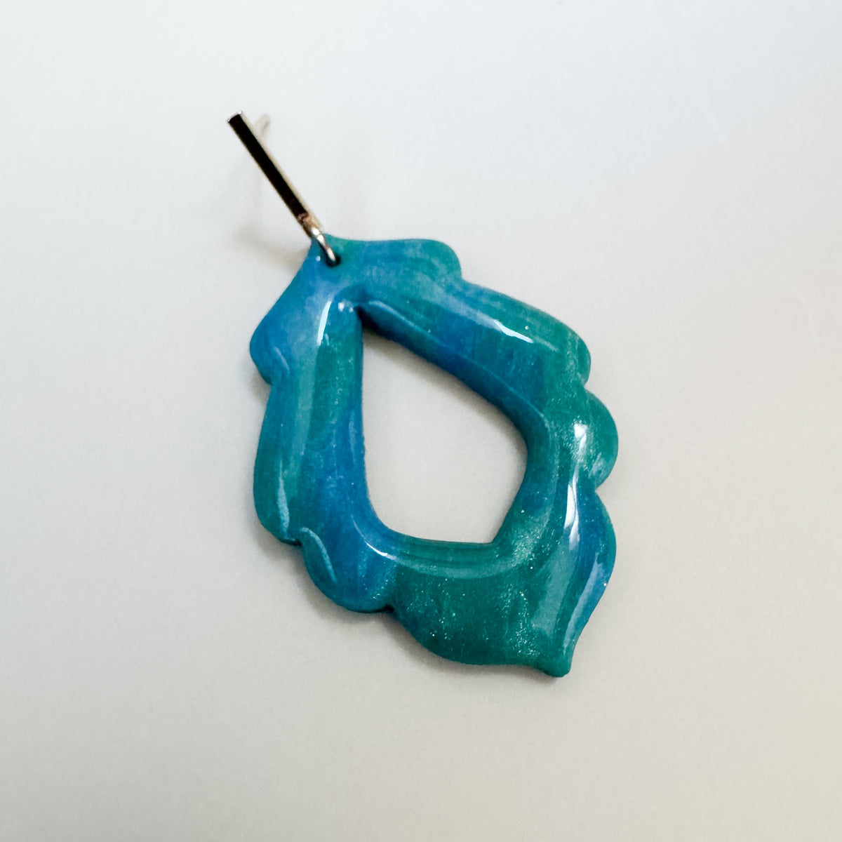 Blue and teal sparkling earring with a thin gold finding.