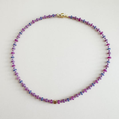 Multicolored beaded necklace on a light gray background