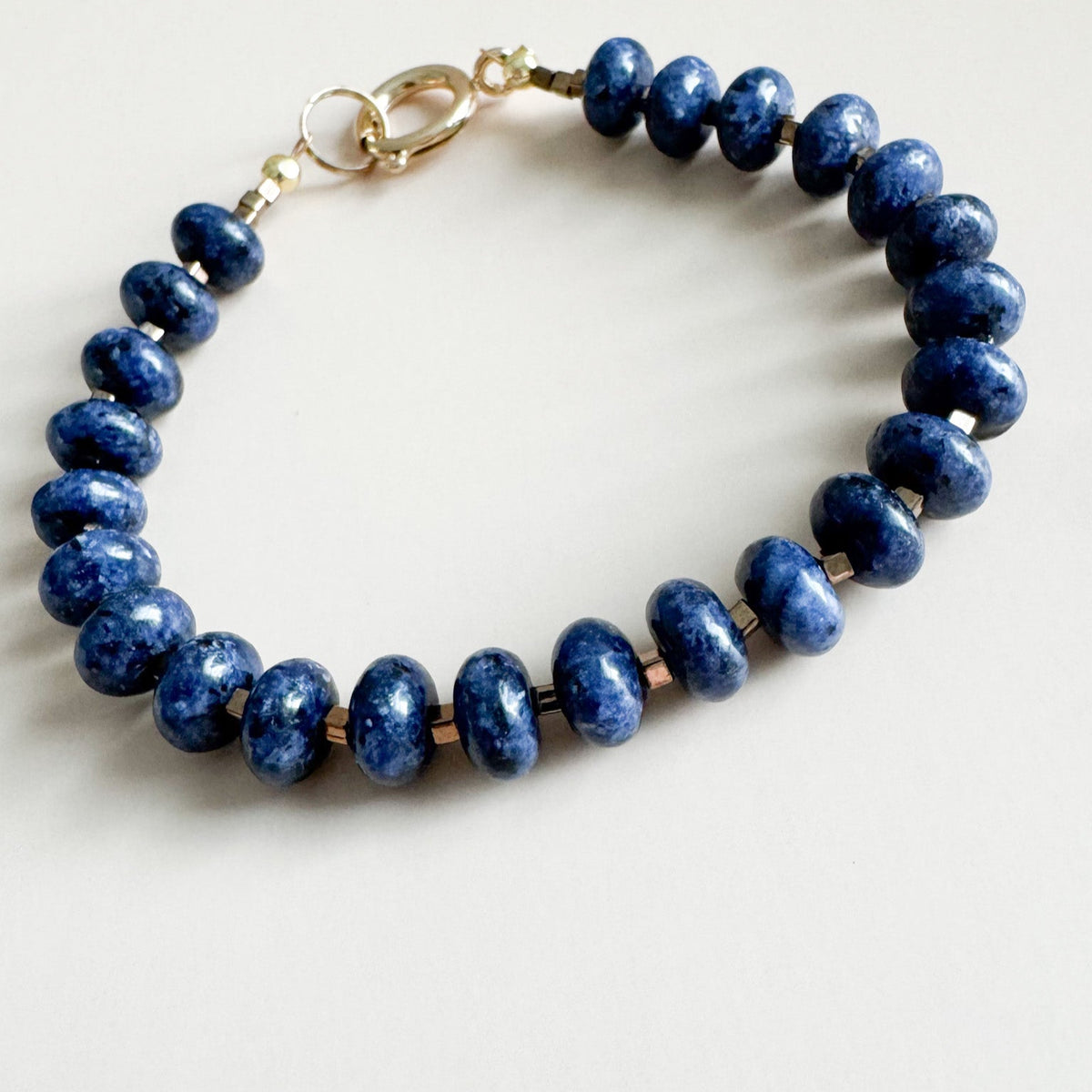 Navy blue beaded bracelet on a white background