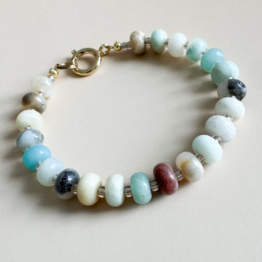 Beaded bracelet with multicolored beads on a light background